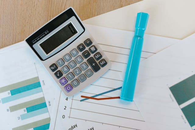 a%20calculator%20and%20highlighter%20on%20top%20of%20financial%20documents